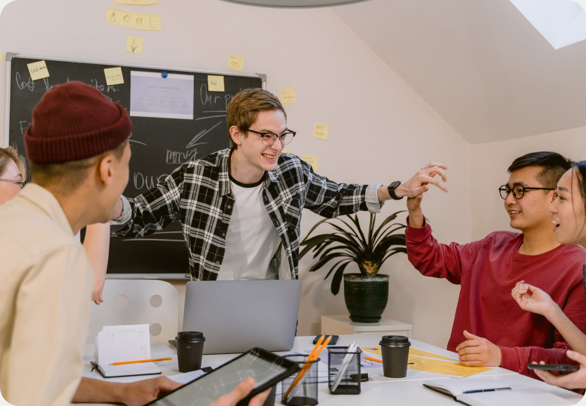 A startup team celebrating around a meeting table